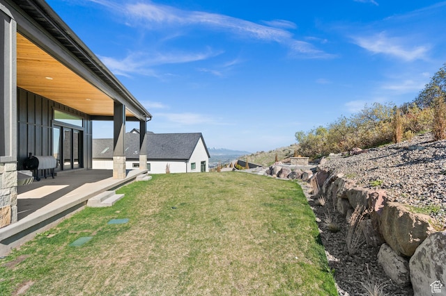 view of yard with a patio and a mountain view