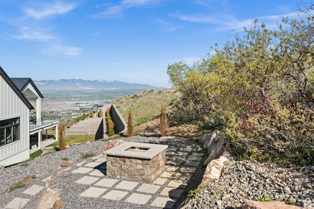 view of patio / terrace featuring a fire pit and a mountain view