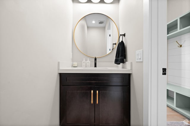 bathroom with visible vents, wood finished floors, and vanity