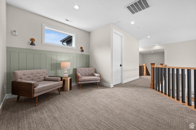 sitting room with wainscoting, an upstairs landing, recessed lighting, and visible vents