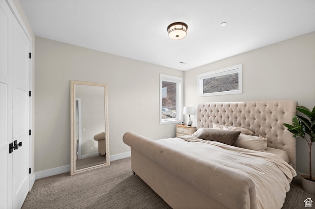 bedroom with baseboards and carpet flooring