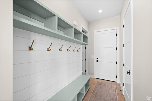 mudroom with baseboards, recessed lighting, and light wood-style flooring