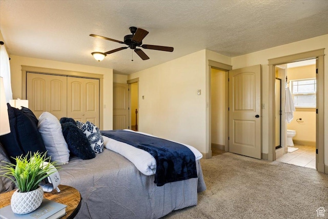 carpeted bedroom featuring ceiling fan, connected bathroom, a closet, and baseboards