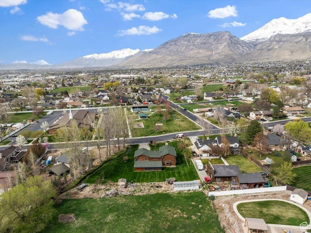 birds eye view of property with a mountain view and a residential view