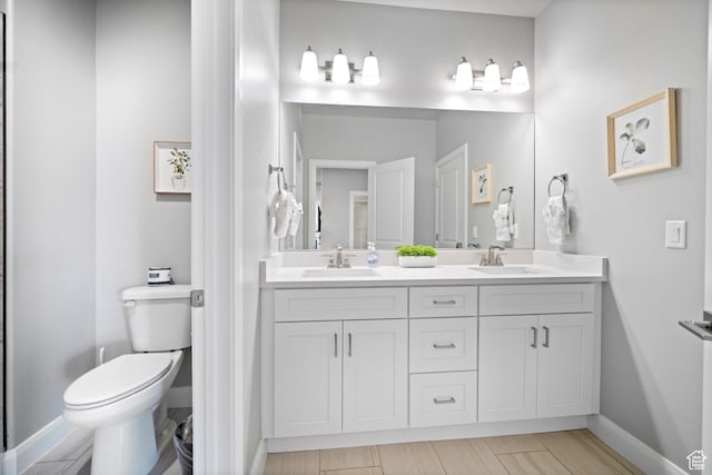 238 N 2020 W # 69, Hurricane, UT 84737 - bathroom featuring double vanity, baseboards, a sink, and toilet
