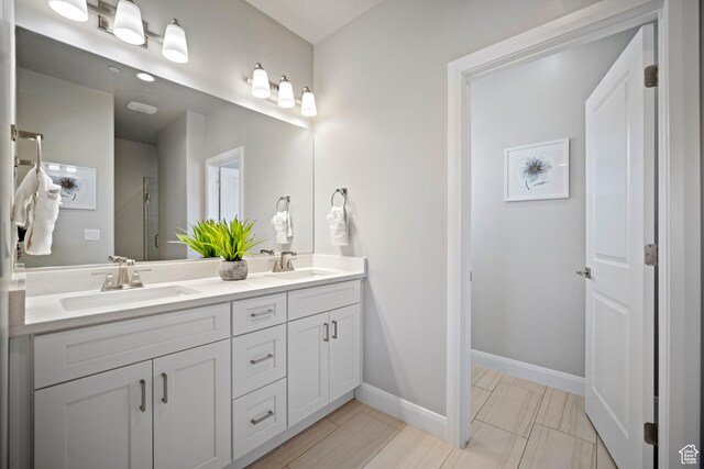 238 N 2020 W # 69, Hurricane, UT 84737 - bathroom with baseboards, double vanity, an enclosed shower, and a sink