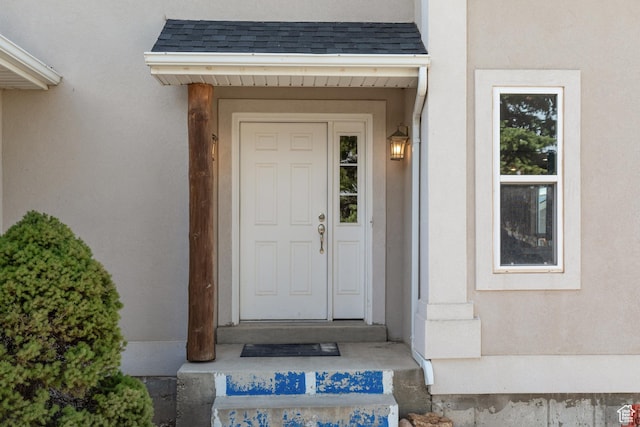 155 S Last Chance Dr, Laketown, UT 84038 - doorway to property featuring a shingled roof and stucco siding