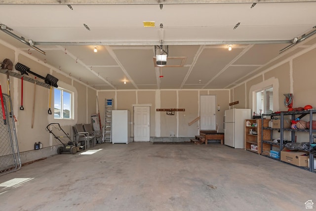 155 S Last Chance Dr, Laketown, UT 84038 - garage with a garage door opener and freestanding refrigerator