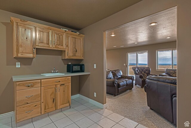 155 S Last Chance Dr, Laketown, UT 84038 - kitchen with open floor plan, black microwave, light countertops, light tile patterned floors, and a sink