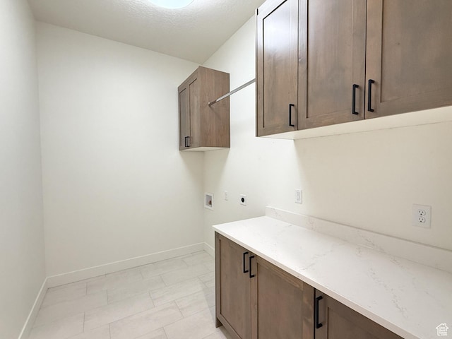 clothes washing area with electric dryer hookup, baseboards, hookup for a washing machine, cabinet space, and marble finish floor