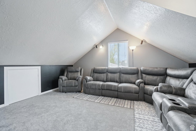 living area featuring vaulted ceiling, a textured ceiling, carpet floors, and baseboards