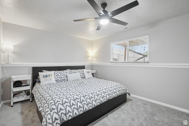 bedroom featuring a textured ceiling, carpet flooring, and baseboards
