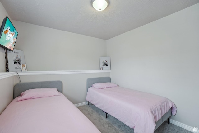 carpeted bedroom featuring baseboards