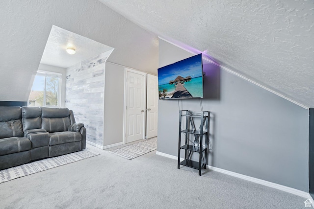 carpeted living room featuring lofted ceiling, baseboards, and a textured ceiling