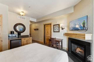 2669 Canyons Resort Dr Unit 207, Park City, UT 84098 - bedroom with baseboards, a glass covered fireplace, and visible vents