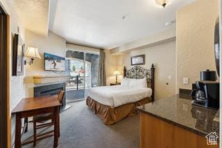 2669 Canyons Resort Dr Unit 207, Park City, UT 84098 - carpeted bedroom with a fireplace and access to exterior