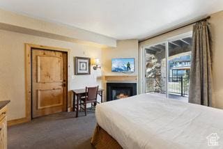 2669 Canyons Resort Dr Unit 207, Park City, UT 84098 - bedroom with access to exterior, dark carpet, and a lit fireplace