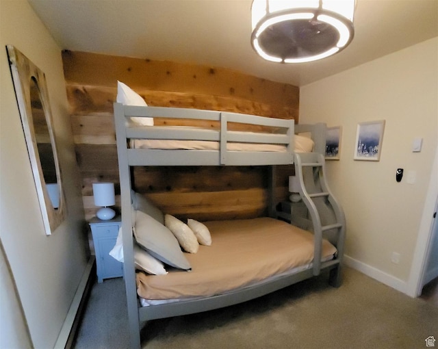 3615 N Wolf Lodge Dr Unit 211, Eden, UT 84310 - carpeted bedroom with a baseboard heating unit, wooden walls, and baseboards