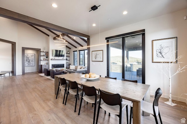 6633 Golden Bear Loop W, Park City, UT 84098 - dining area with light wood-type flooring, lofted ceiling with beams, recessed lighting, and a fireplace
