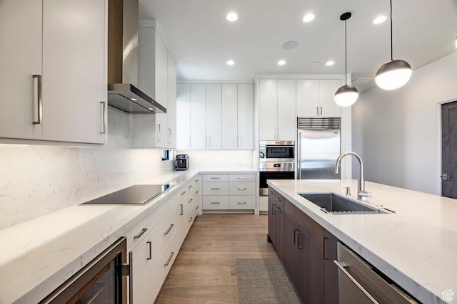 6633 Golden Bear Loop W, Park City, UT 84098 - kitchen with wall chimney range hood, pendant lighting, a sink, stainless steel appliances, and recessed lighting