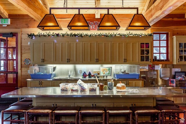 6633 Golden Bear Loop W, Park City, UT 84098 - kitchen featuring wood ceiling, a breakfast bar, wood walls, and beam ceiling