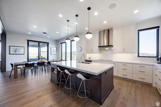 6633 Golden Bear Loop W, Park City, UT 84098 - kitchen featuring a center island with sink, wall chimney range hood, recessed lighting, hardwood / wood-style flooring, and a sink