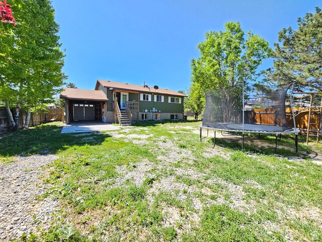 3500 W 6875 S, West Jordan, UT 84084 - back of house featuring a trampoline and an attached garage
