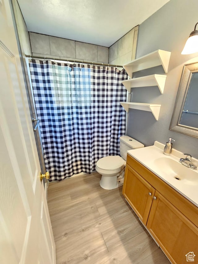 3500 W 6875 S, West Jordan, UT 84084 - bathroom featuring wood finished floors, toilet, a shower with shower curtain, and vanity