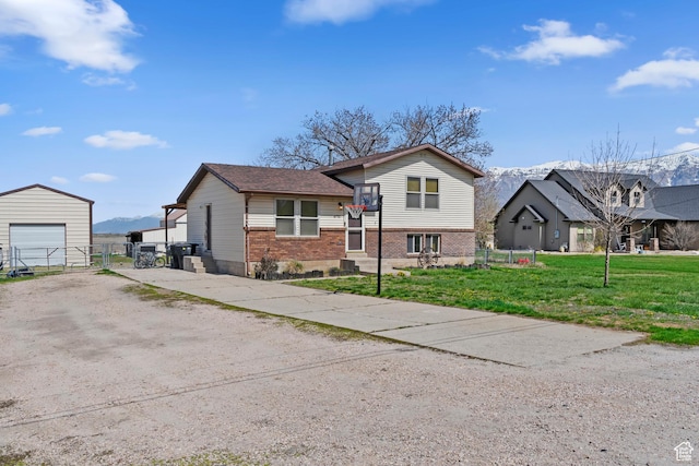 4710 W 2200 N, Plain City, UT 84404 - tri-level home with a front yard, a detached garage, an outdoor structure, brick siding, and driveway