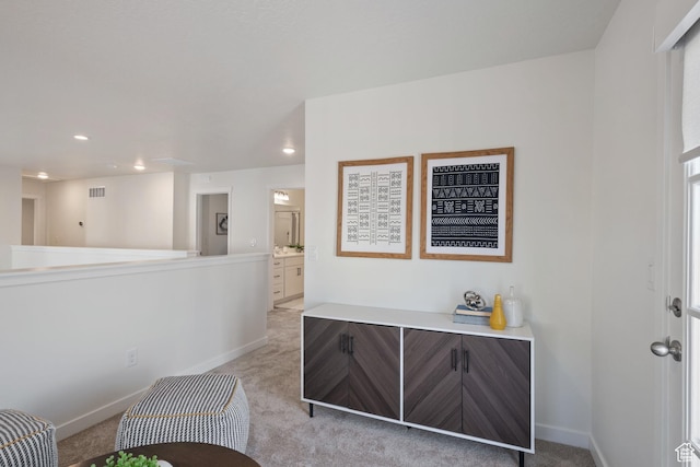 foyer with light colored carpet, baseboards, visible vents, and recessed lighting