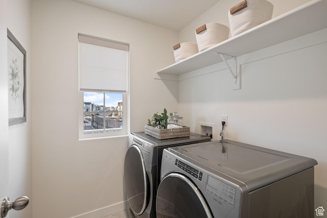 laundry room featuring laundry area, separate washer and dryer, and baseboards