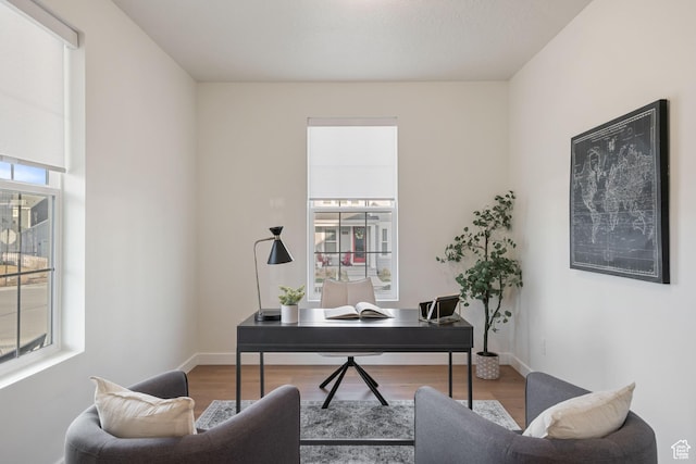 office space with wood finished floors and baseboards