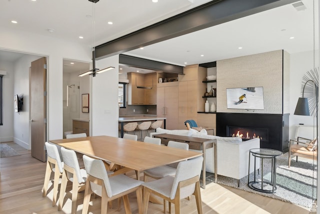 3595 Ridgeline Dr, Park City, UT 84098 - dining space with light wood finished floors, baseboards, a large fireplace, and recessed lighting