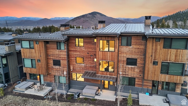 3595 Ridgeline Dr, Park City, UT 84098 - back of property with a mountain view, metal roof, a patio area, and a chimney