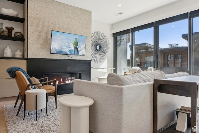 3595 Ridgeline Dr, Park City, UT 84098 - living area featuring a glass covered fireplace, visible vents, and wood finished floors