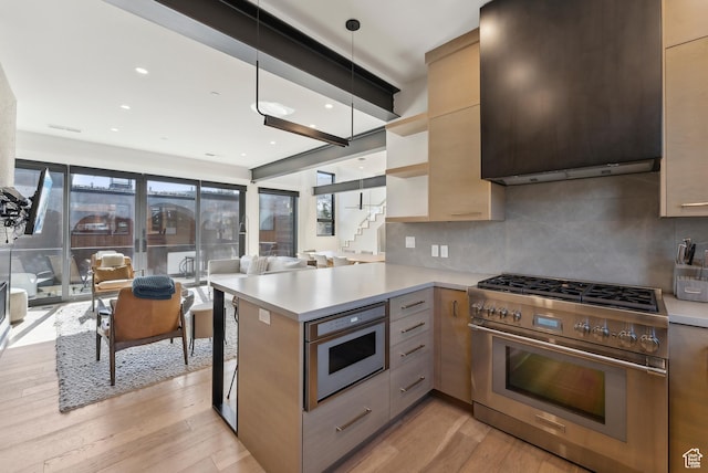 3595 Ridgeline Dr, Park City, UT 84098 - kitchen with stainless steel range, light countertops, light wood-type flooring, and decorative backsplash