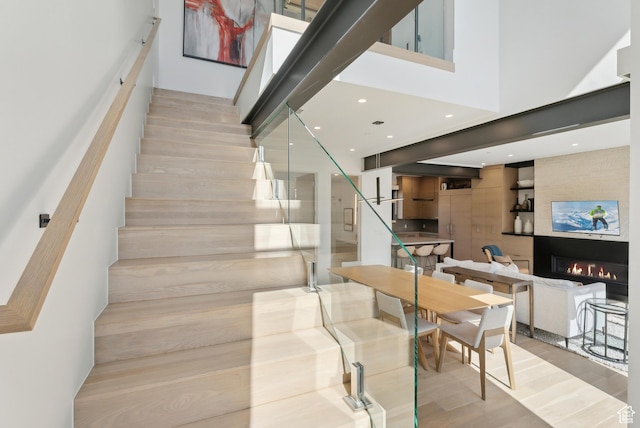 3595 Ridgeline Dr, Park City, UT 84098 - stairs featuring a high ceiling, a large fireplace, and wood finished floors