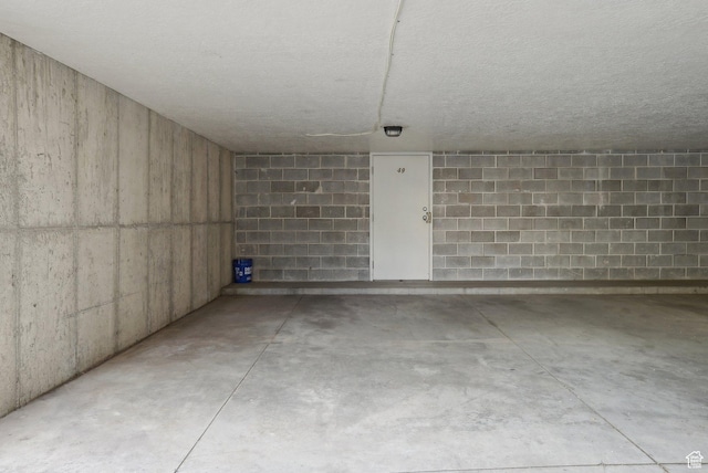 below grade area featuring concrete block wall