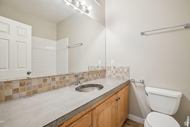 bathroom with tasteful backsplash, vanity, visible vents, and toilet