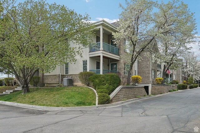 view of building exterior with stairway and cooling unit
