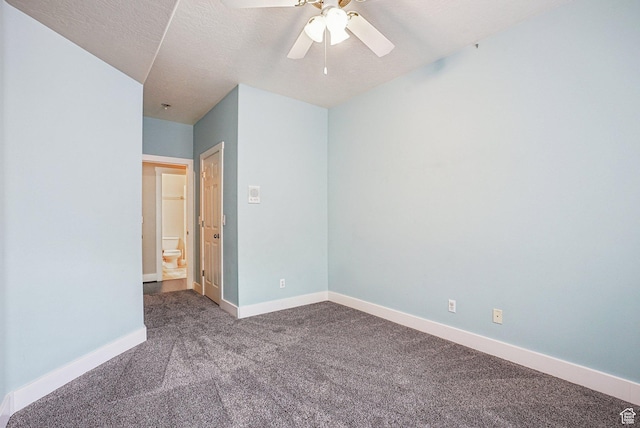 empty room with a textured ceiling, ceiling fan, baseboards, and carpet