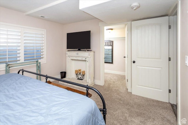 bedroom featuring baseboards, visible vents, and carpet floors