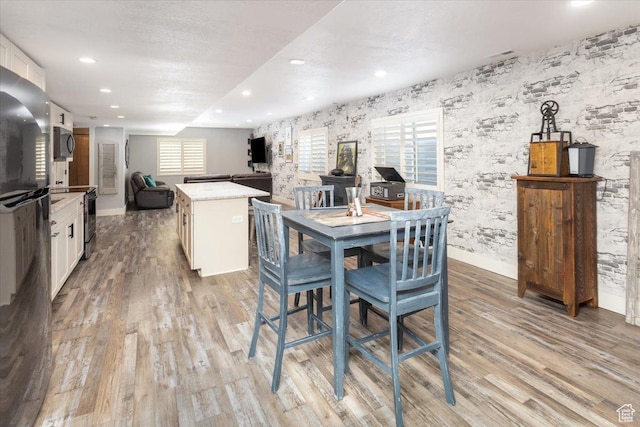 dining room with recessed lighting, light wood finished floors, baseboards, and wallpapered walls