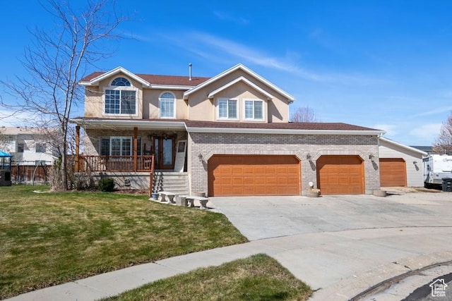 traditional-style home featuring covered porch, a front yard, brick siding, an attached garage, and driveway