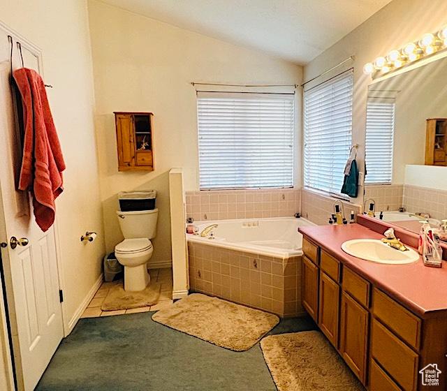 8366 S Cobble Cir W, West Jordan, UT 84081 - bathroom with lofted ceiling, a bath, vanity, and toilet