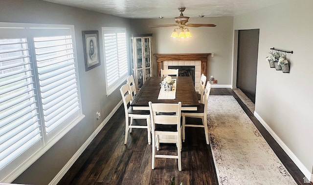 8366 S Cobble Cir W, West Jordan, UT 84081 - dining space featuring a tile fireplace, baseboards, a ceiling fan, and wood finished floors