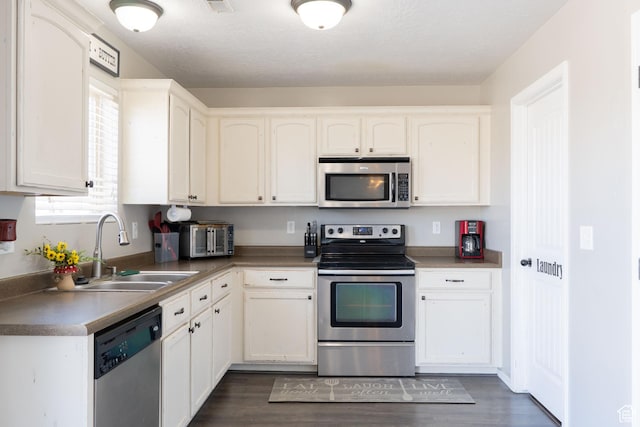 583 E 2680 S, Vernal, UT 84078 - kitchen with a sink, white cabinets, dark wood-style floors, and stainless steel appliances