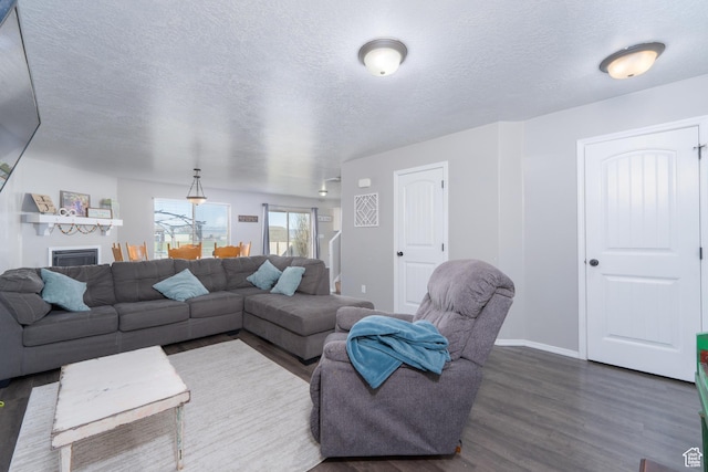 583 E 2680 S, Vernal, UT 84078 - living room with dark wood-type flooring, baseboards, and a textured ceiling