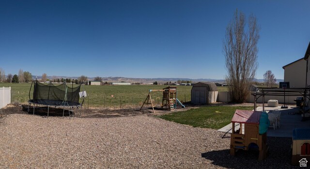 583 E 2680 S, Vernal, UT 84078 - view of yard featuring an outbuilding, a storage unit, fence, a playground, and a trampoline