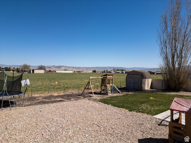 583 E 2680 S, Vernal, UT 84078 - view of yard with an outbuilding, a shed, fence, a playground, and a trampoline
